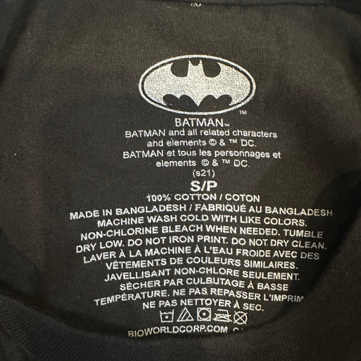 Batman T-shirt inner label showing cotton and care details