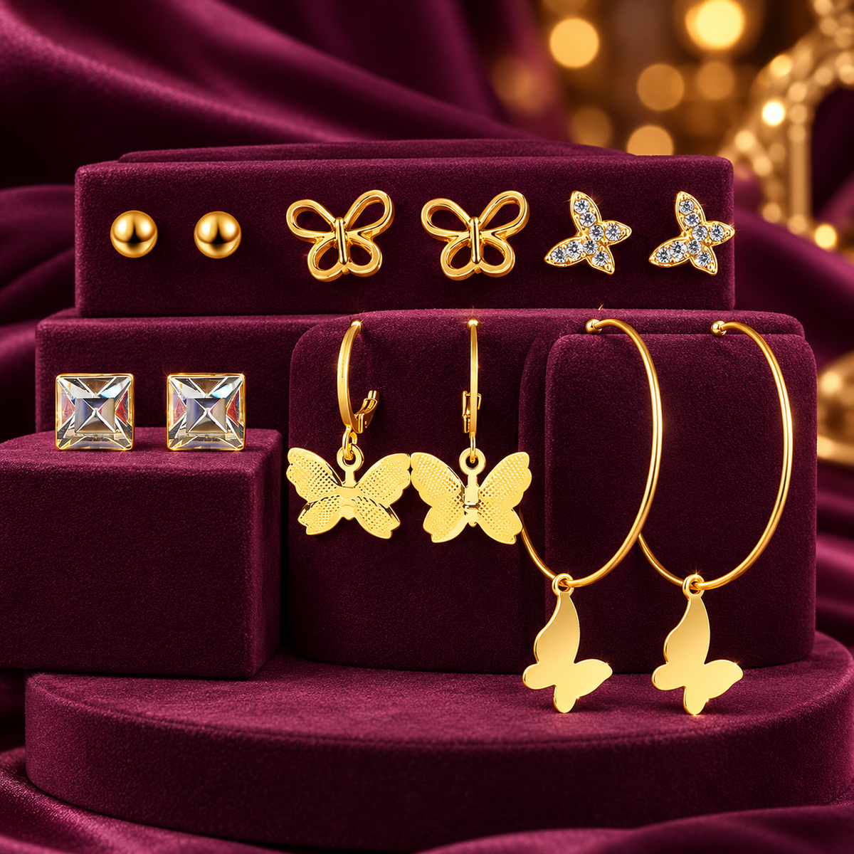 Gold-Tone Butterfly, Ball and Square Stud Earrings – 6-Pair Set on a decorative coloured jewellery display