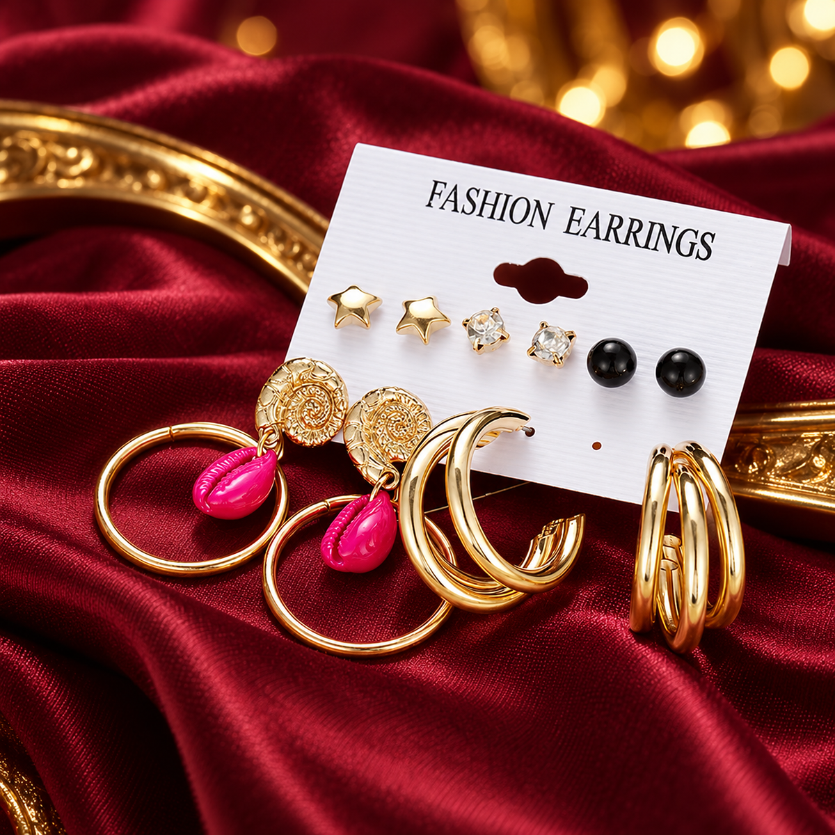 Gold-Tone Star, Crystal and Statement Hoop Earrings – 6-Pair Set on decorative coloured satin background