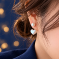 Faux Pearl Heart Drop Earrings with Gold-Tone Detail with a coloured studio background