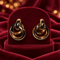 Gold-Tone Interlocking Multi-Ring Statement Earrings on burgundy satin and velvet