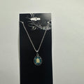 Necklace featuring blue teardrop halo pendant