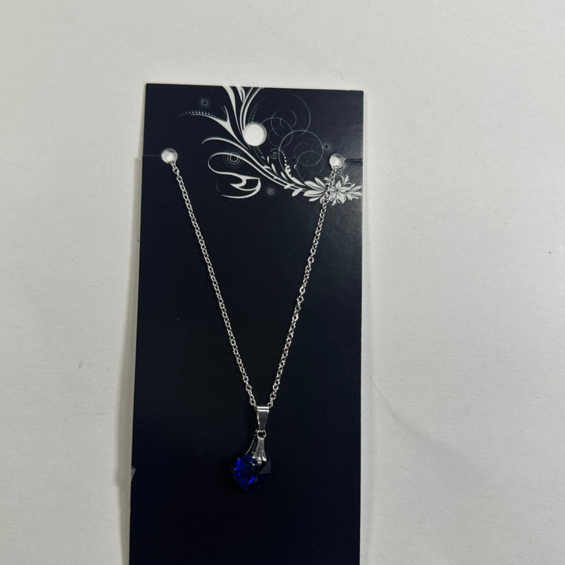 Necklace featuring dark blue heart pendant