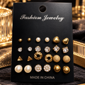 Twelve pairs of assorted gold-tone fashion stud earrings on black jewelry card