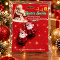 Santa flashing earrings in original packaging against festive Christmas background